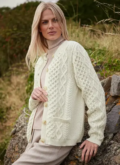 Woman in White Aran Cardigan on Beach Ruby Aran Merino Lumber in Natural